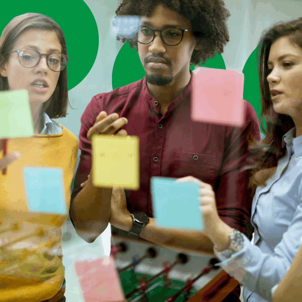 a group of people looking at sticky notes on a glass wall